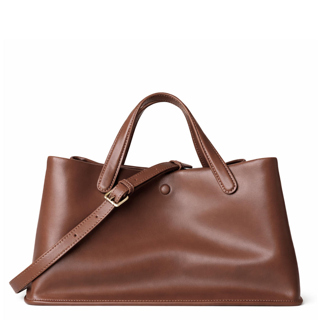 Brown leather handbag with a strap on a white background