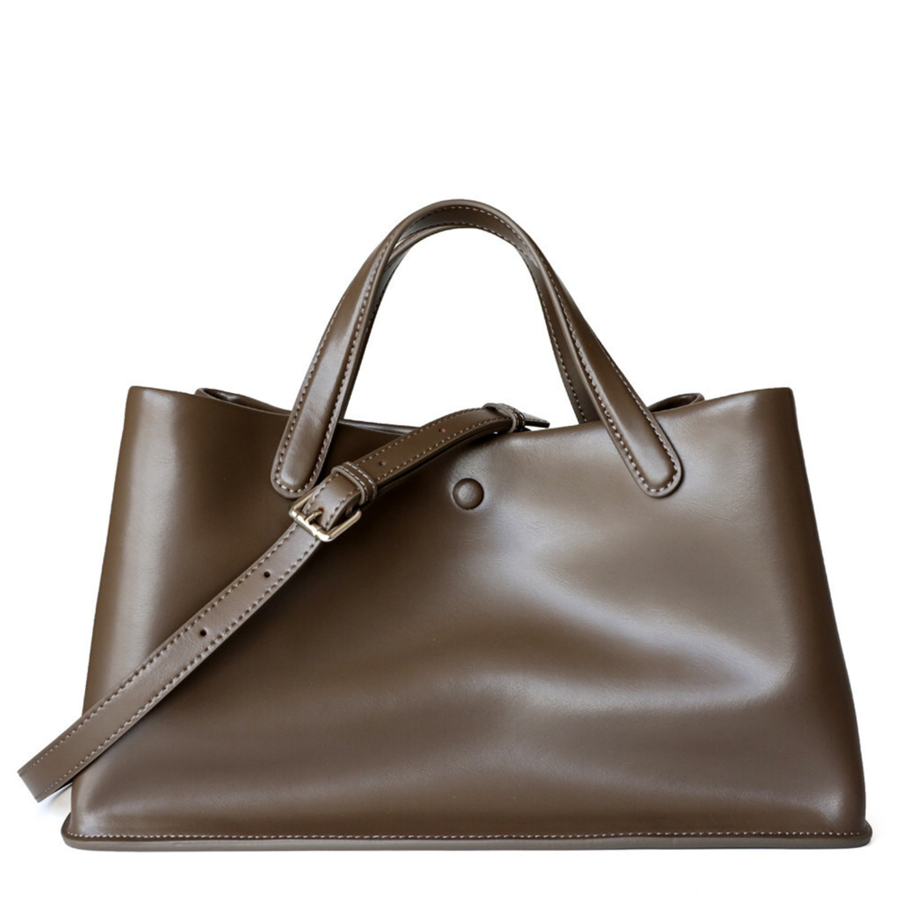 Brown leather handbag with a strap on a white background
